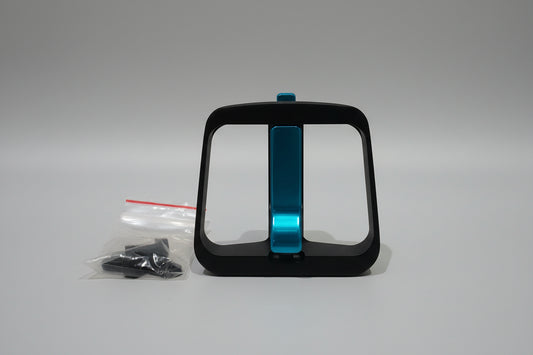 Black and blue bike water bottle holder on a wooden surface with a white background